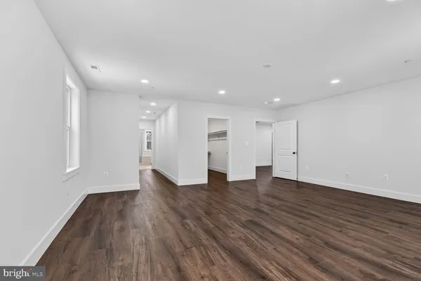 a view of a room with wooden floor
