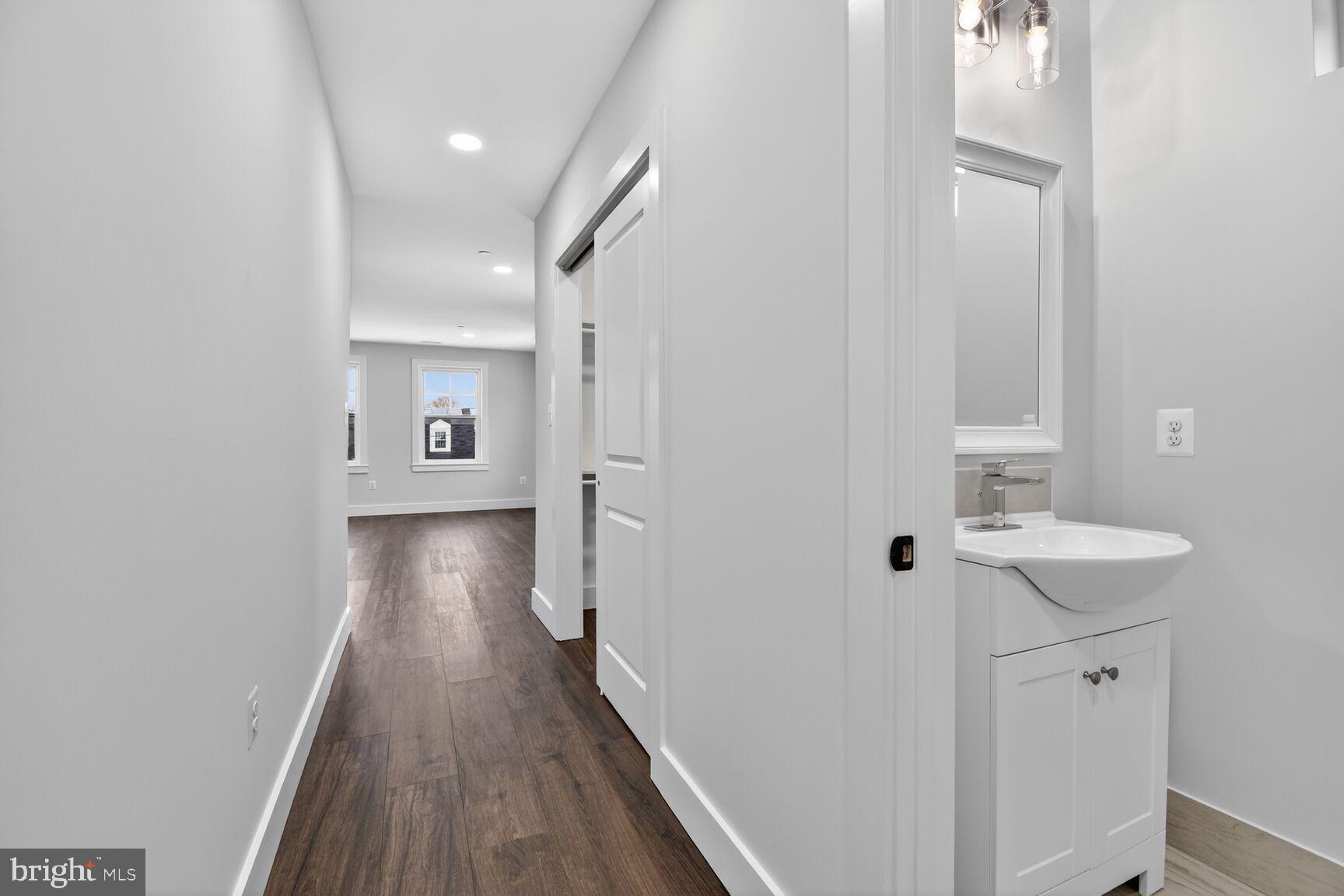 13102 Ideal Drive Silver Spring, MD 20906 - Photo 26 of 48 a view of a hallway with wooden floor and a bathroom