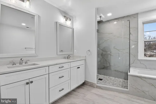 a bathroom with a bathtub a shower a sink and toilet