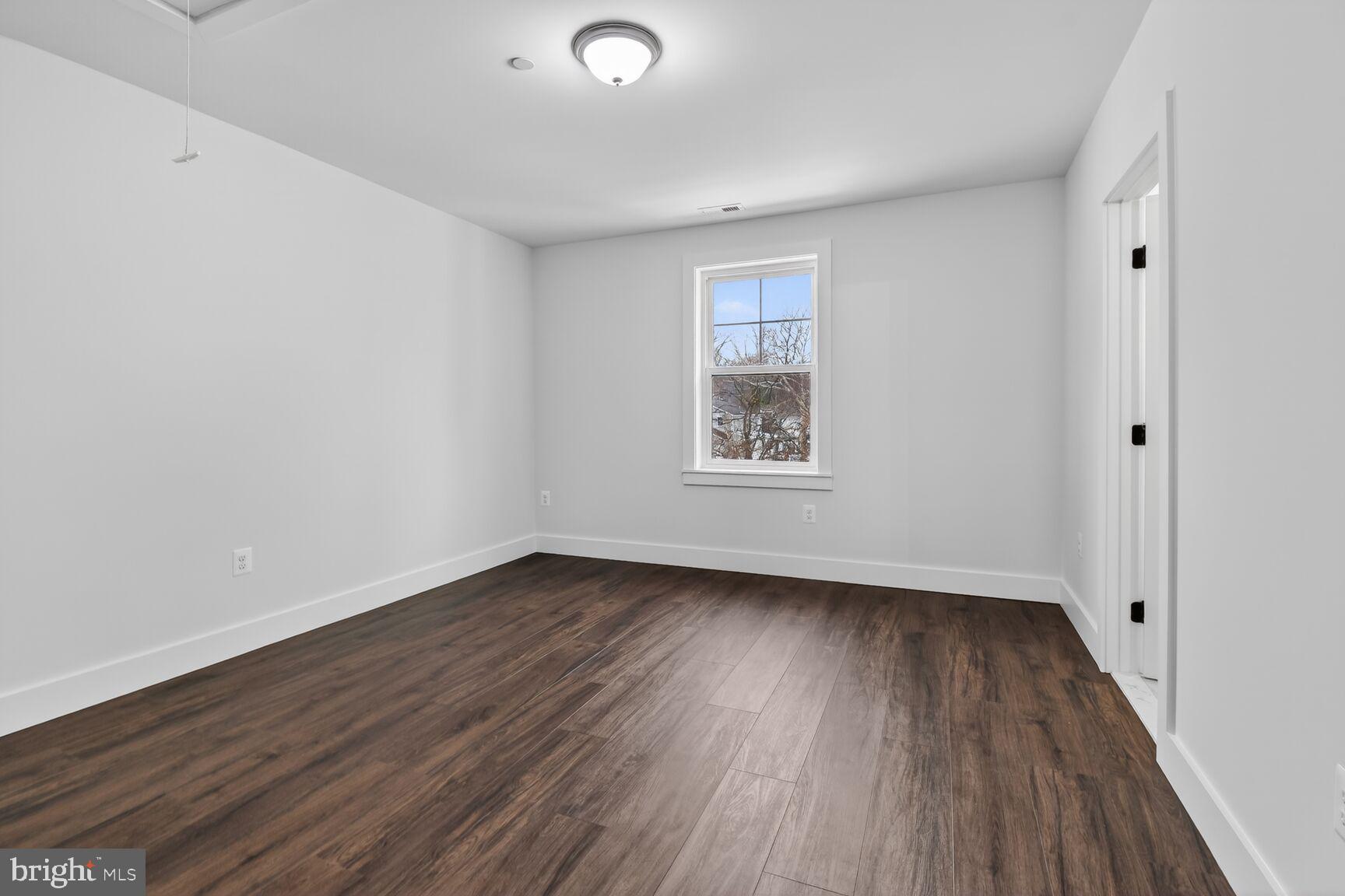 13102 Ideal Drive Silver Spring, MD 20906 - Photo 31 of 48 an empty room with wooden floor and windows