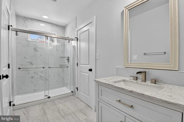 a view of an empty room with wooden floor and closet