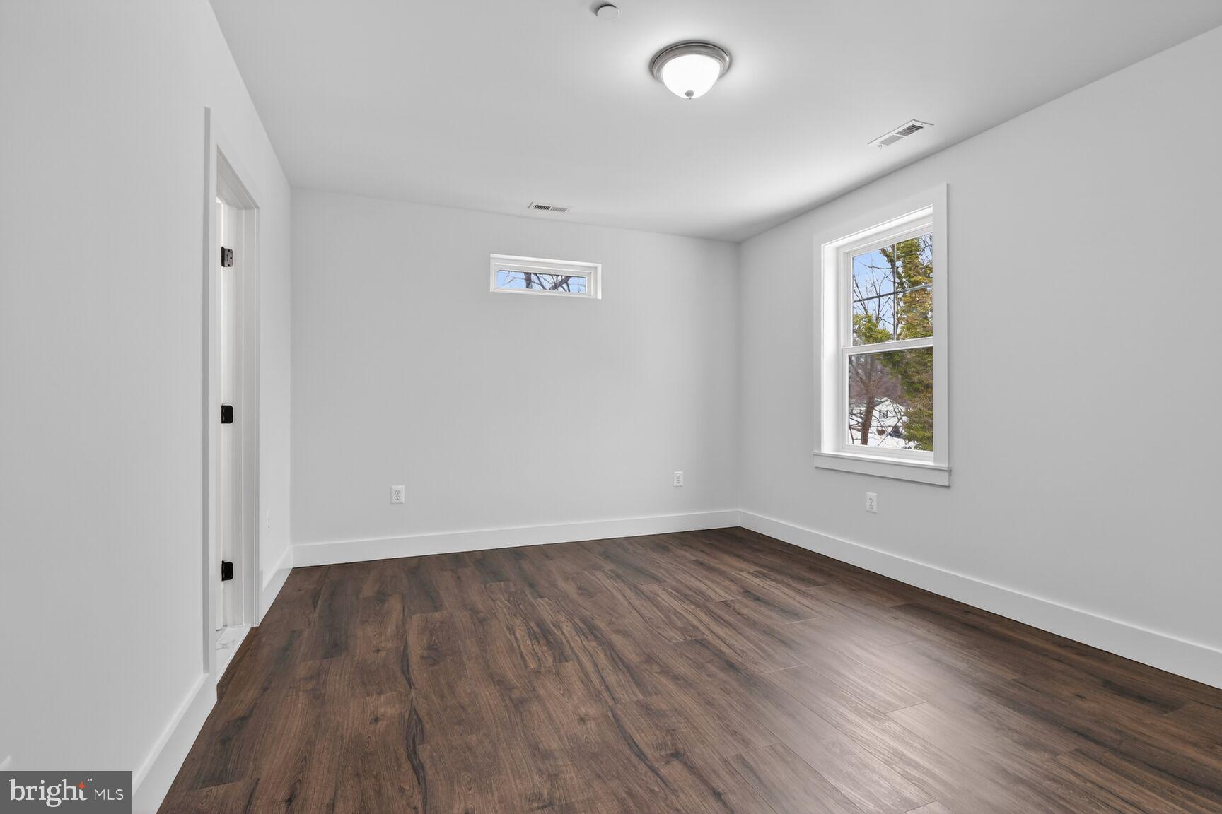 13102 Ideal Drive Silver Spring, MD 20906 - Photo 35 of 48 an empty room with wooden floor and windows