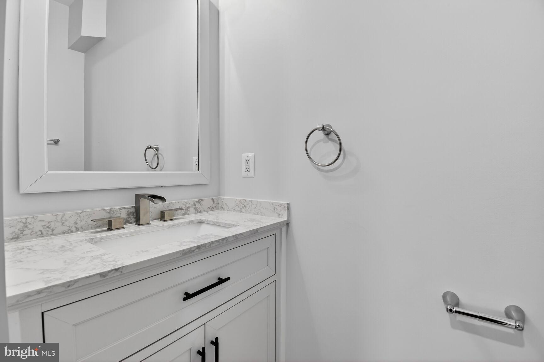 13102 Ideal Drive Silver Spring, MD 20906 - Photo 37 of 48 a bathroom with a granite countertop sink and a mirror
