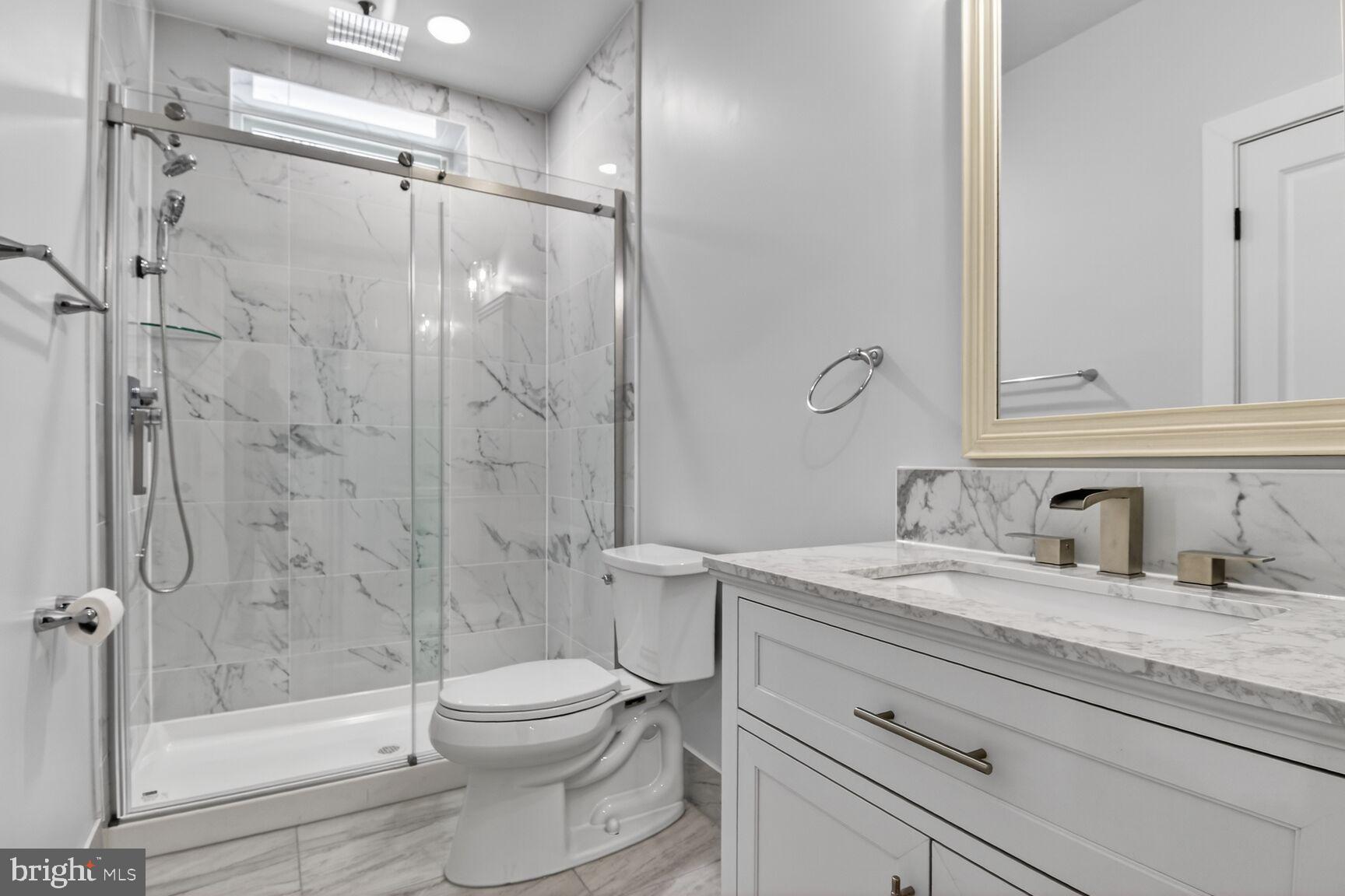 13102 Ideal Drive Silver Spring, MD 20906 - Photo 39 of 48 a bathroom with a granite countertop sink toilet and shower