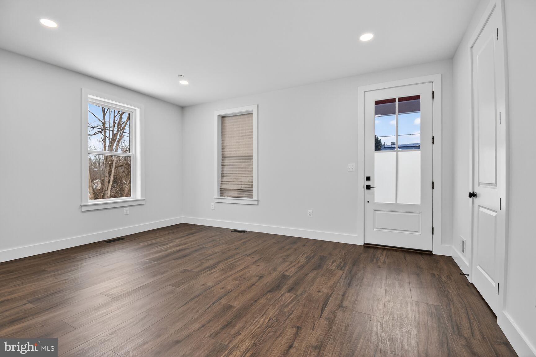 13102 Ideal Drive Silver Spring, MD 20906 - Photo 4 of 48 an empty room with wooden floor and windows