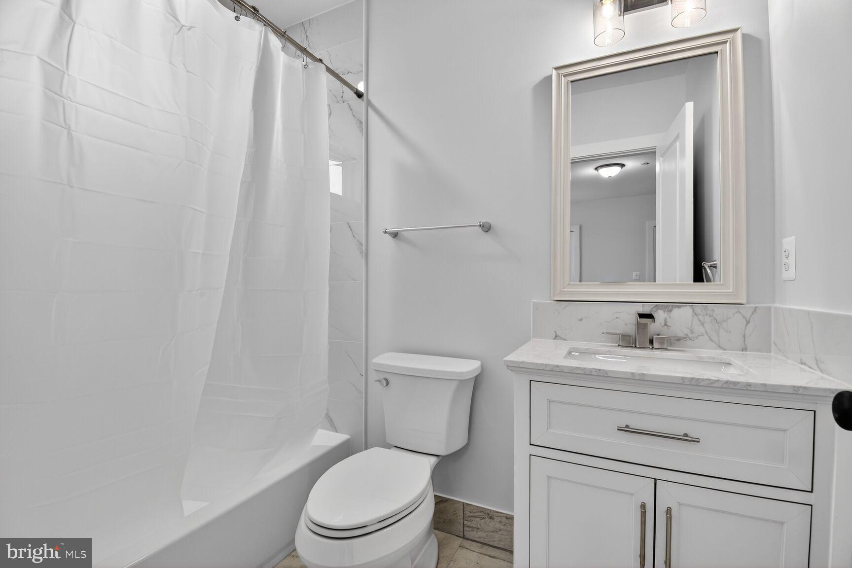 13102 Ideal Drive Silver Spring, MD 20906 - Photo 45 of 48 a bathroom with a granite countertop toilet sink and mirror