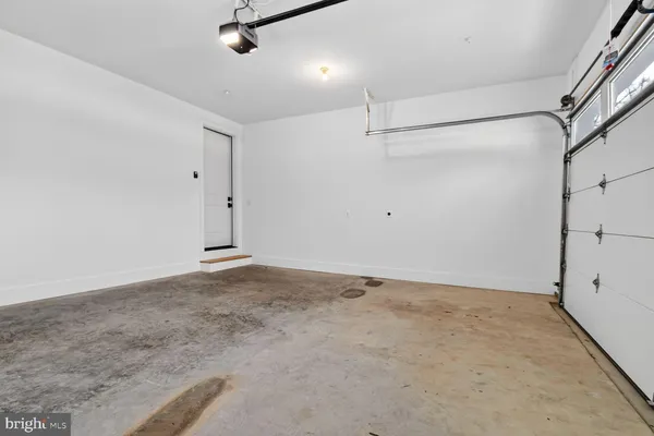 a view of a hallway with wooden floor and glass door