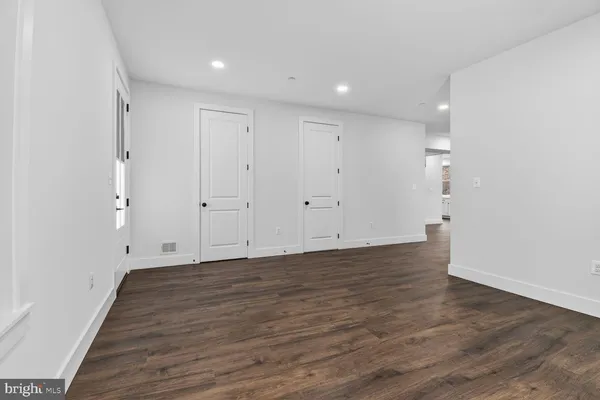 a view of room with wooden floor