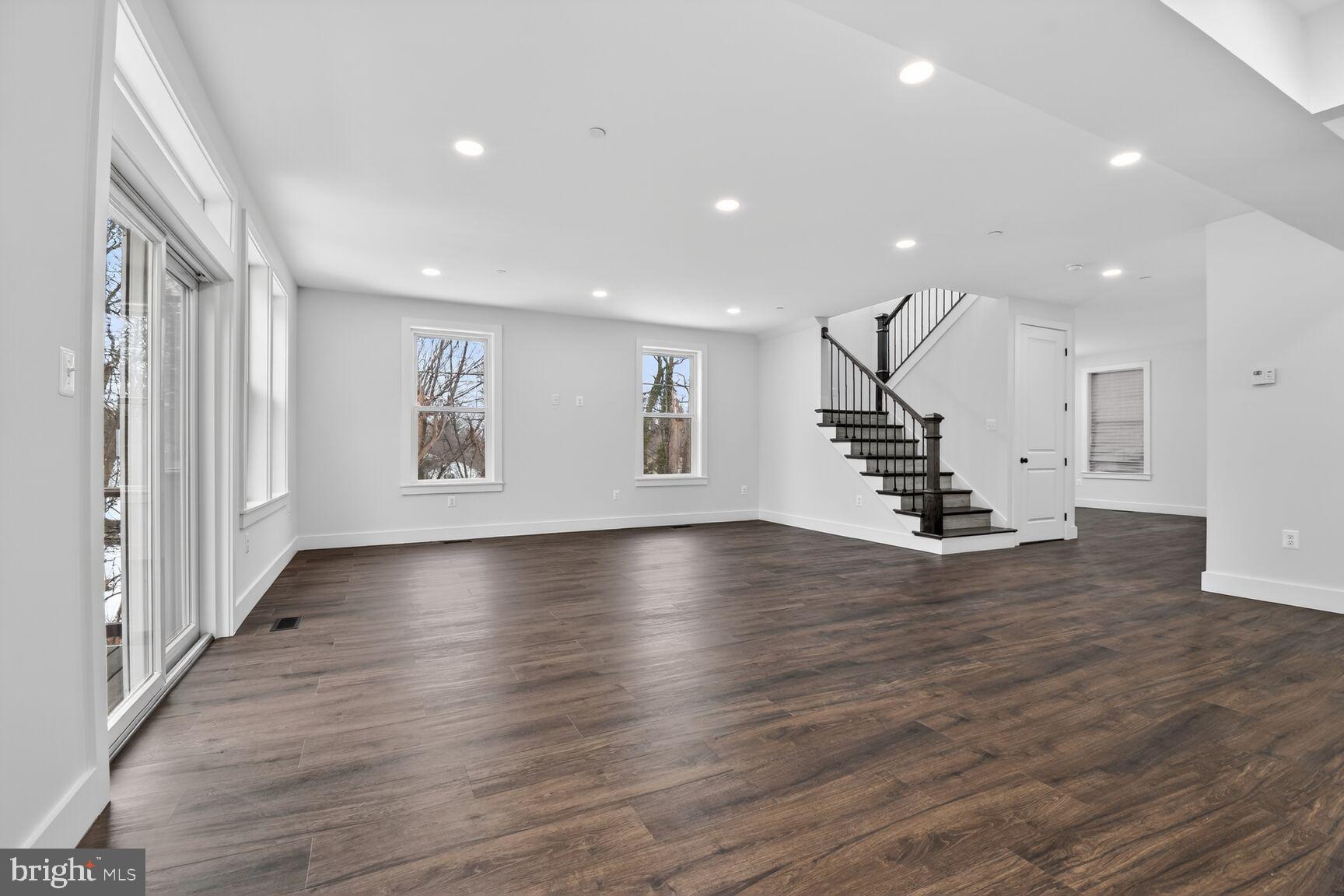 13102 Ideal Drive Silver Spring, MD 20906 - Photo 7 of 48 an empty room with wooden floor windows and staircase