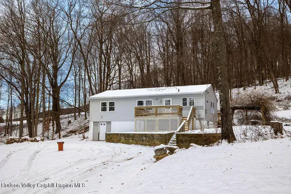 a view of a backyard with snow on the road