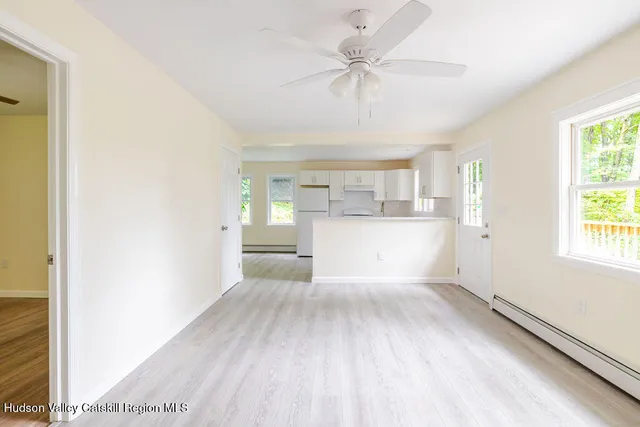 a view of a kitchen with a sink and wooden floor