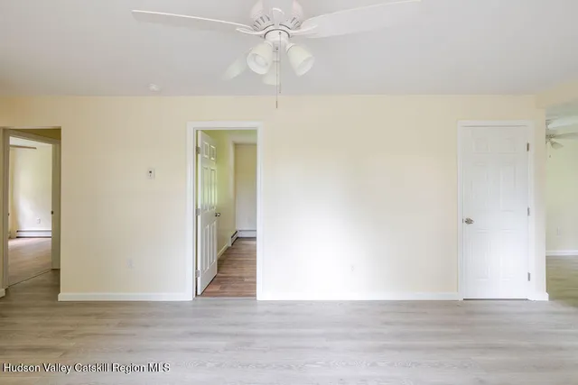 a view of an empty room with wooden floor