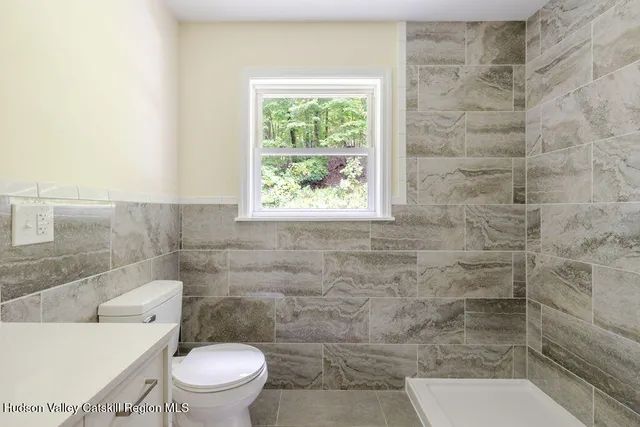 a bathroom with a toilet a sink and a shower