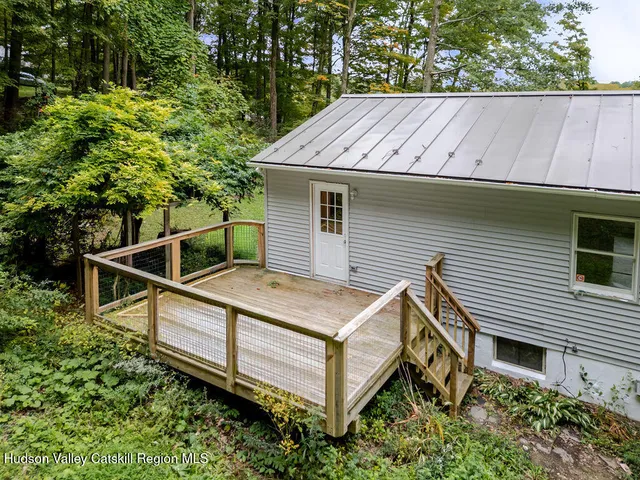 a view of a house with a yard and wooden fence