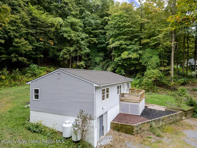 a aerial view of a house with yard and large trees