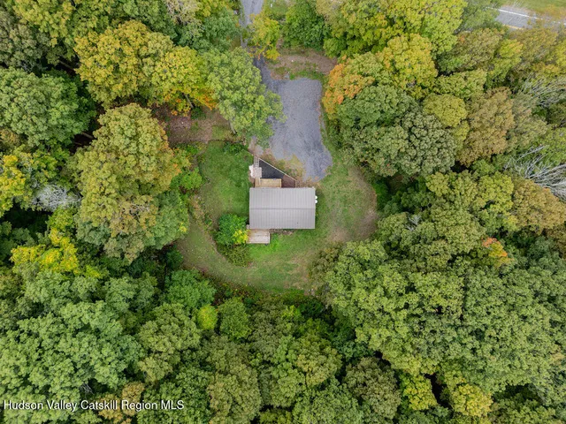 an aerial view of a house with a yard