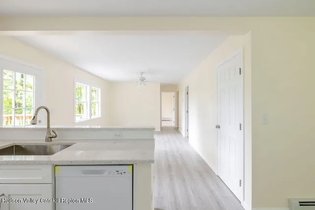 a kitchen with a sink cabinets and wooden floor