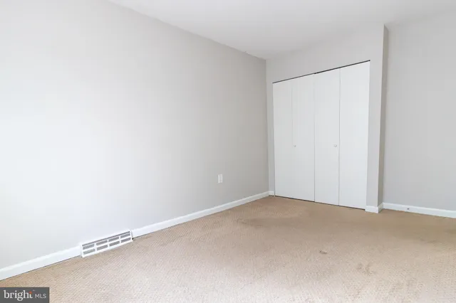 a bathroom with a toilet and a rug