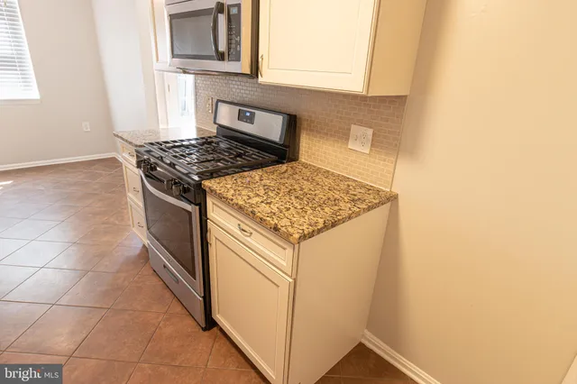 a kitchen with a stove and a microwave