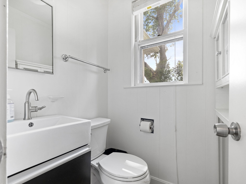 47 Alleyne Street Boston, MA 02132 - Photo 13 of 30 a bathroom with a toilet a sink and a window