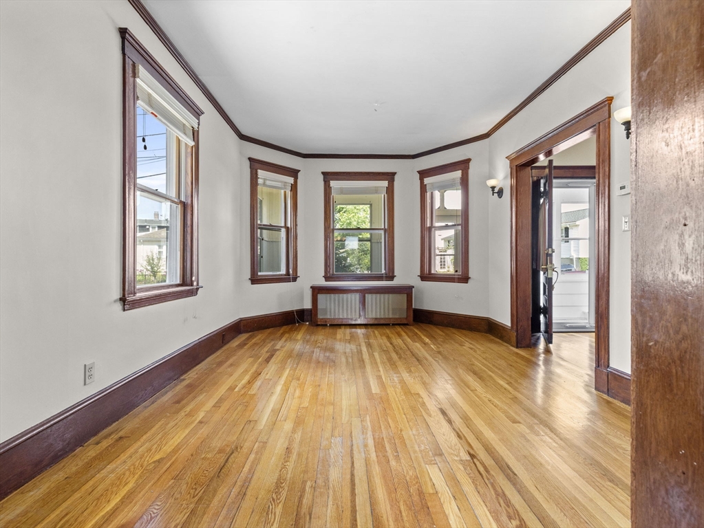 47 Alleyne Street Boston, MA 02132 - Photo 15 of 30 a view of an empty room with wooden floor and a window