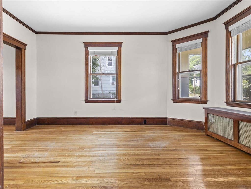 47 Alleyne Street Boston, MA 02132 - Photo 19 of 30 a view of an empty room with window and wooden floor