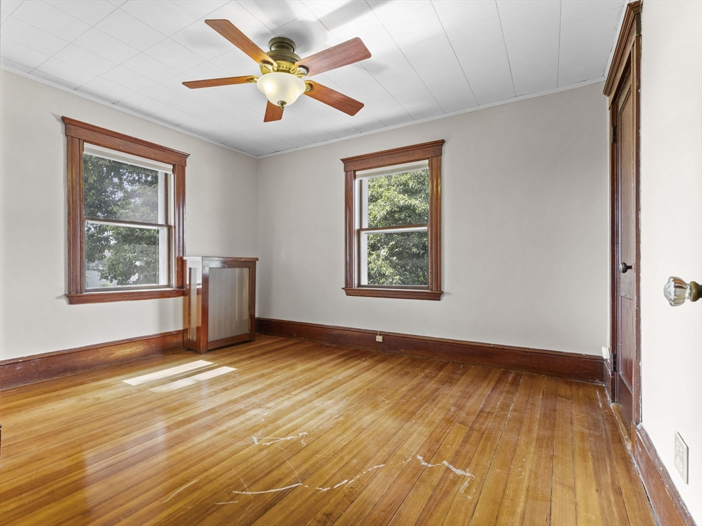 47 Alleyne Street Boston, MA 02132 - Photo 23 of 30 a view of an empty room with a window and wooden floor