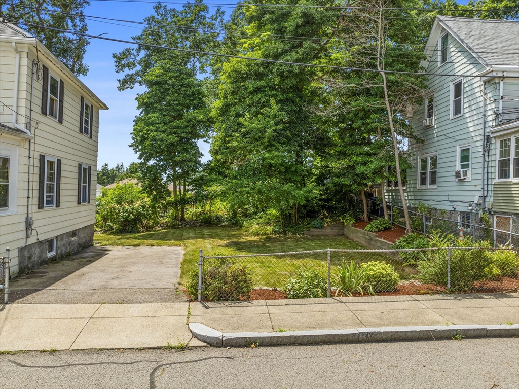 47 Alleyne Street Boston, MA 02132 - Photo 5 of 30 a view of a patio in front of a brick house with a large windows