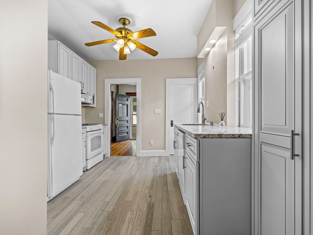 47 Alleyne Street Boston, MA 02132 - Photo 9 of 30 a view of a kitchen with a sink refrigerator and wooden floor