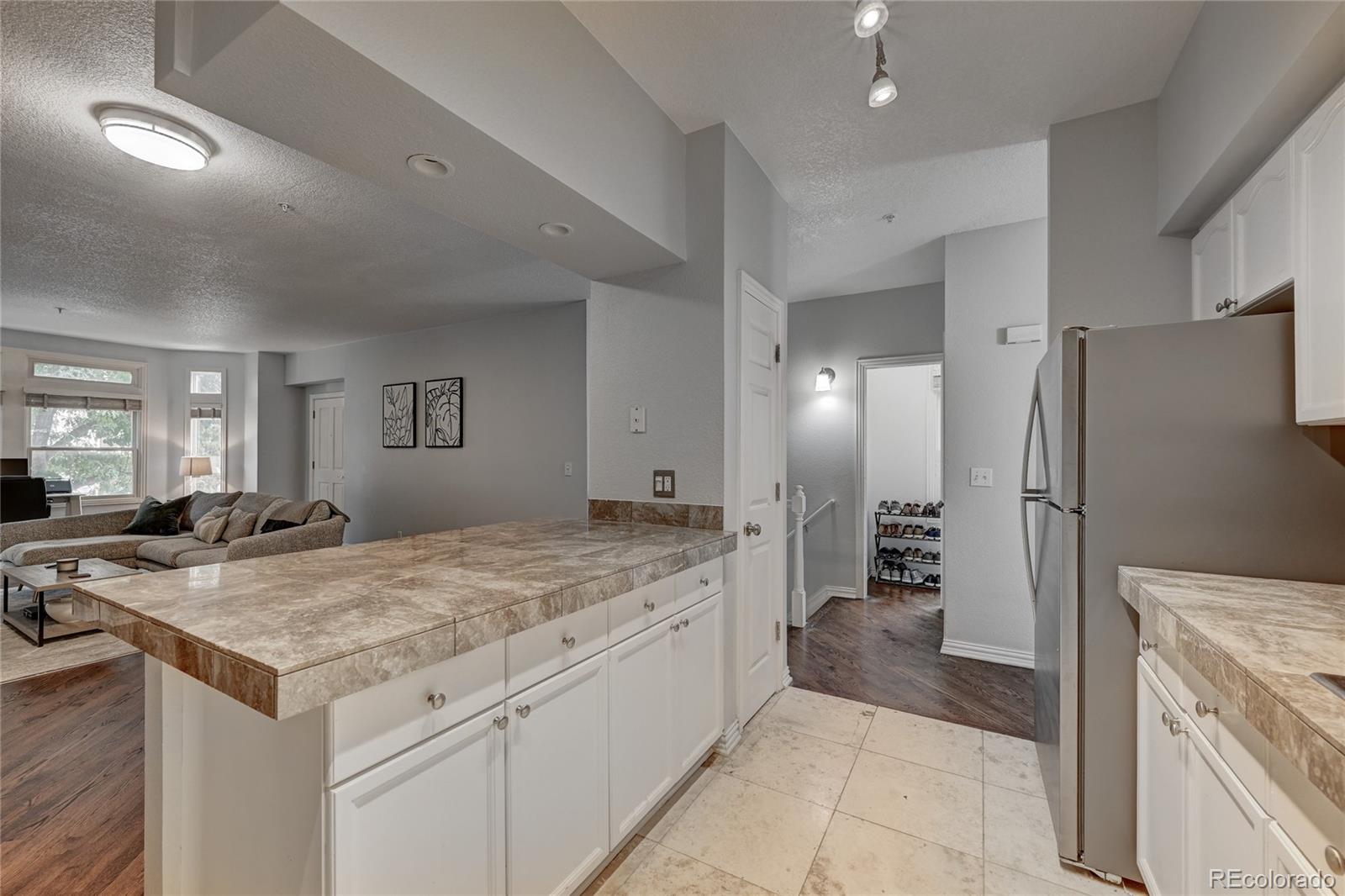 45 Jackson Street, Unit D Denver, CO 80206 - Photo 11 of 26 a kitchen with a stove a refrigerator and a sink
