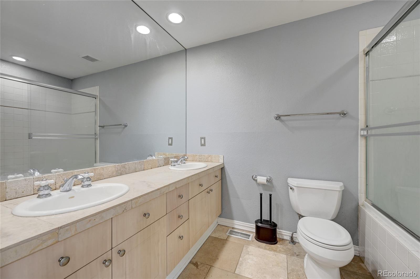 45 Jackson Street, Unit D Denver, CO 80206 - Photo 16 of 26 a bathroom with a toilet a sink a mirror and a shower