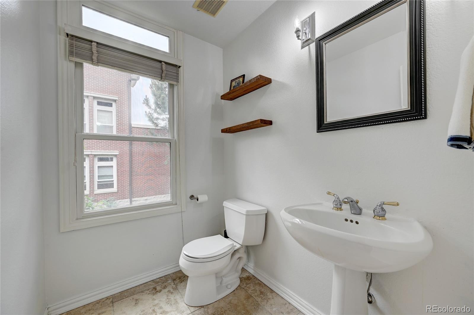 45 Jackson Street, Unit D Denver, CO 80206 - Photo 17 of 26 a white toilet sitting next to a bathroom sink