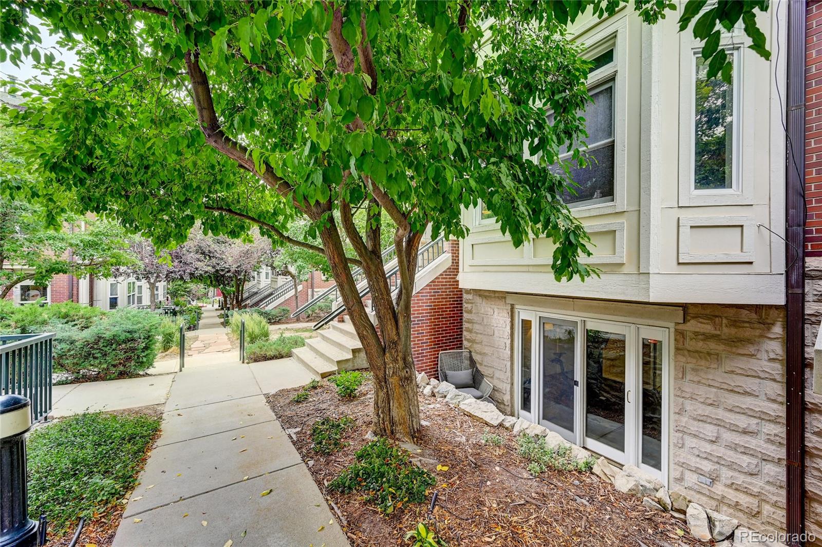 45 Jackson Street, Unit D Denver, CO 80206 - Photo 26 of 26 a front view of a house with a garden and trees