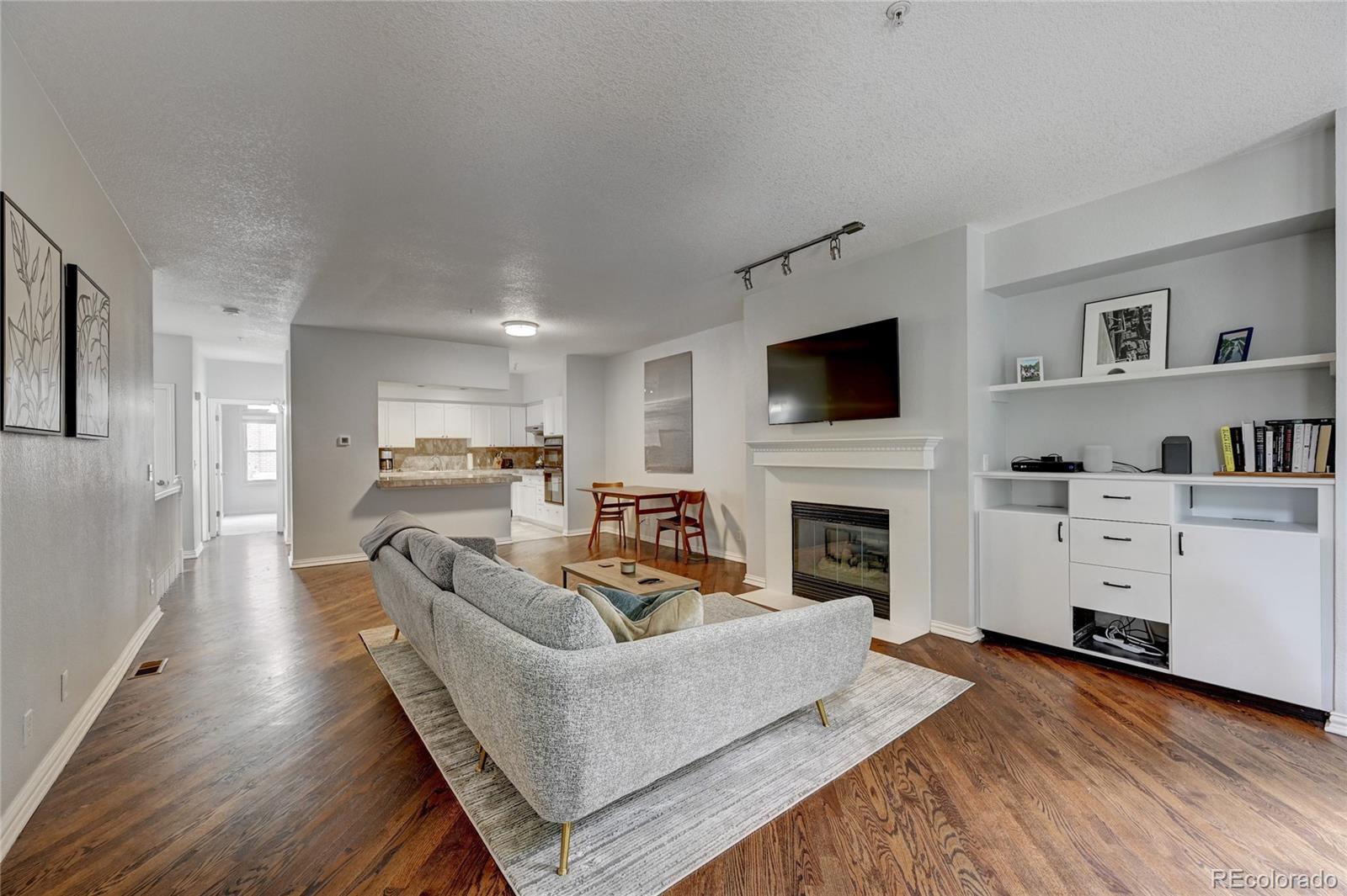 45 Jackson Street, Unit D Denver, CO 80206 - Photo 4 of 26 a living room with furniture fireplace and flat screen tv