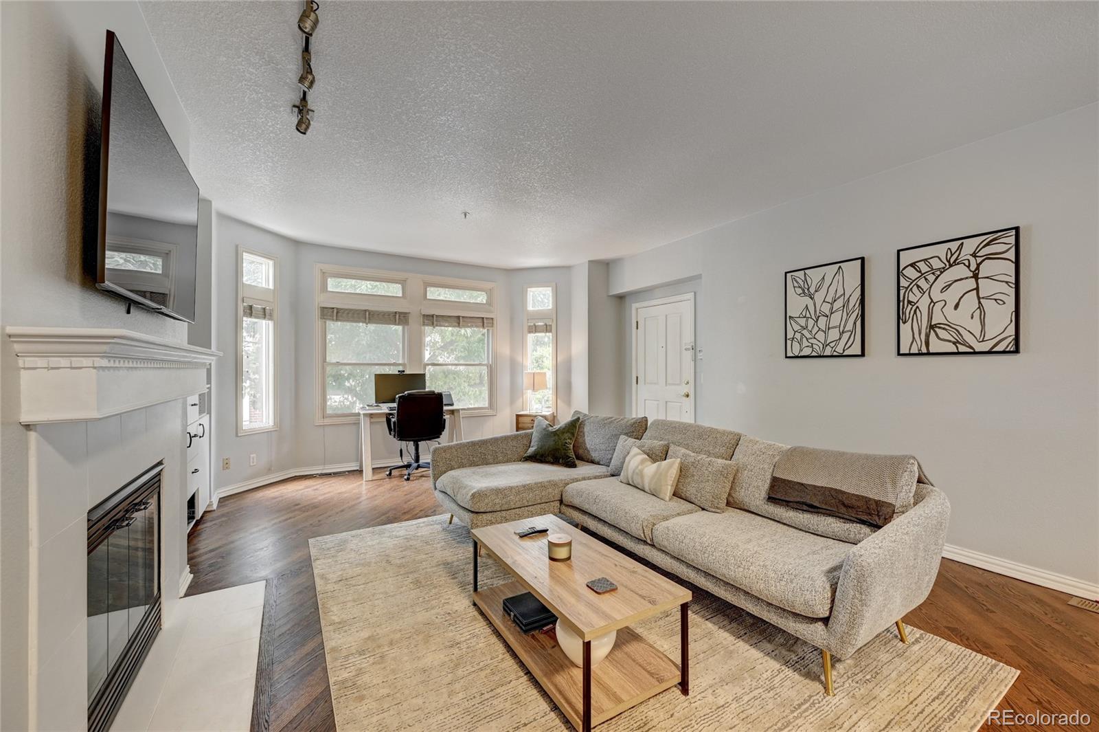45 Jackson Street, Unit D Denver, CO 80206 - Photo 6 of 26 a living room with furniture window and flat screen tv