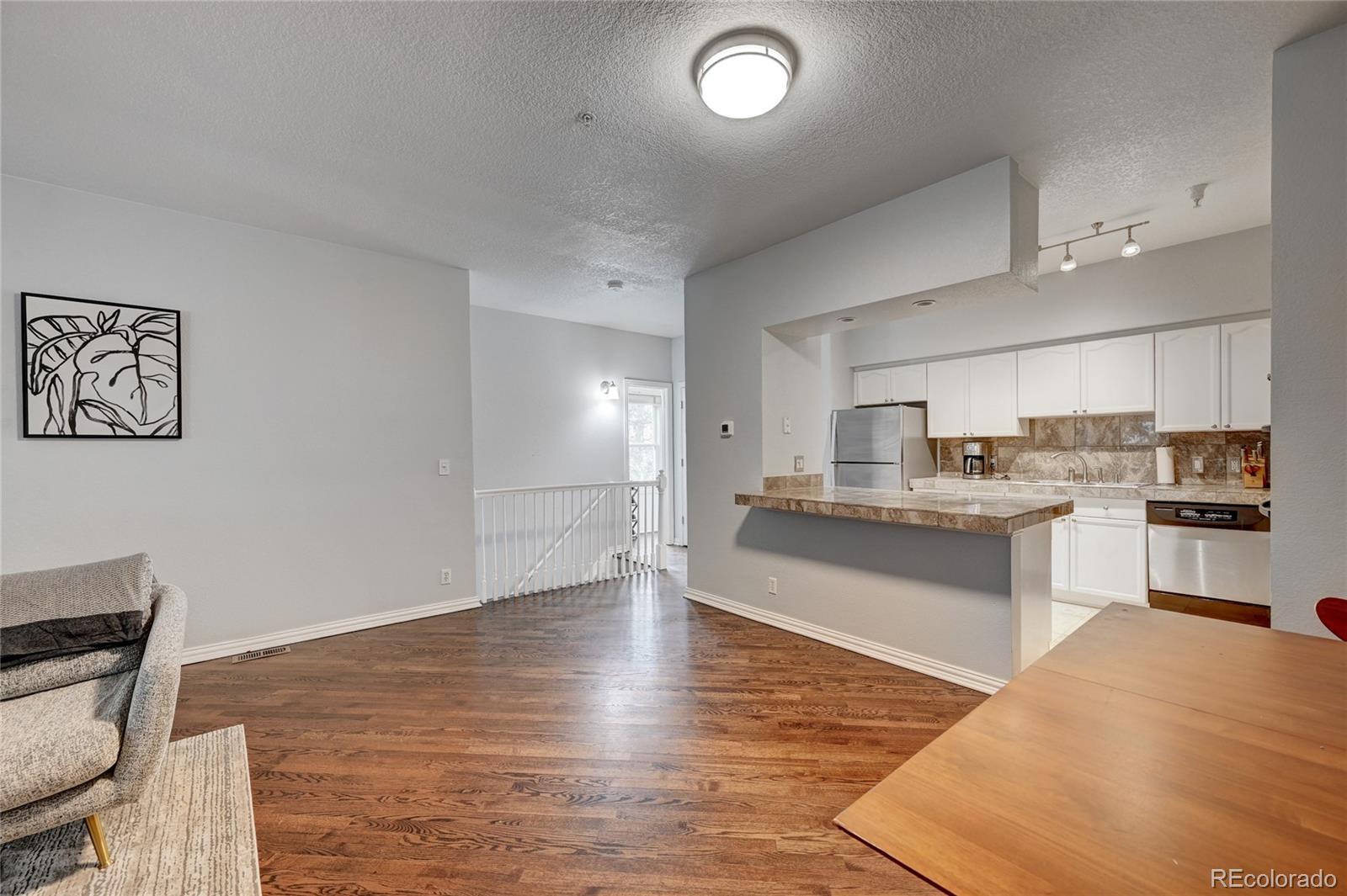 45 Jackson Street, Unit D Denver, CO 80206 - Photo 9 of 26 a kitchen with granite countertop a sink cabinets and stainless steel appliances