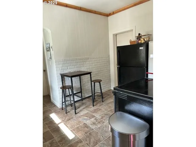 a kitchen with stainless steel appliances granite countertop a refrigerator and a stove top oven