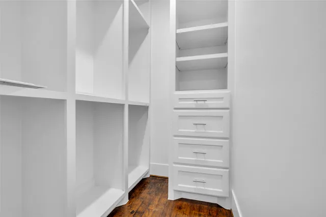 a view of walk in closet with empty racks