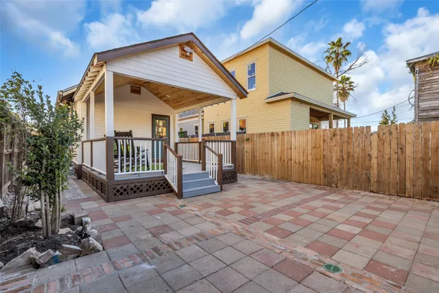 a view of a house with wooden fence