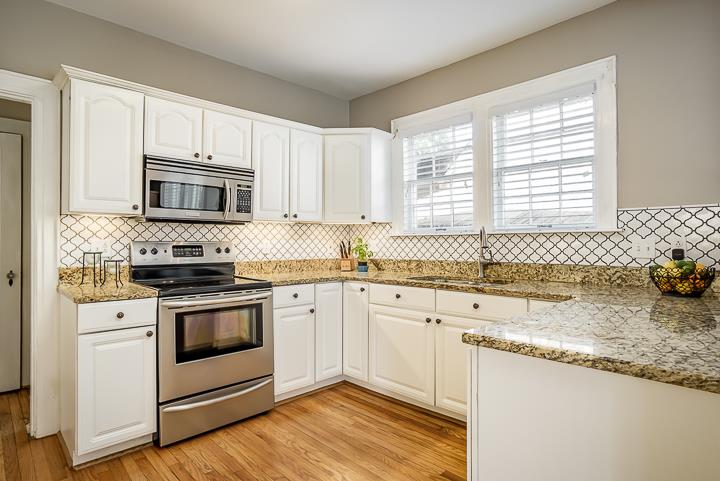 237 Cherokee Road Nashville, TN 37205 - Photo 13 of 30 a kitchen with granite countertop a stove a sink and a microwave