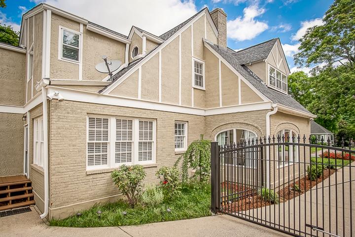 237 Cherokee Road Nashville, TN 37205 - Photo 3 of 30 a view of a white house with large windows and a small yard