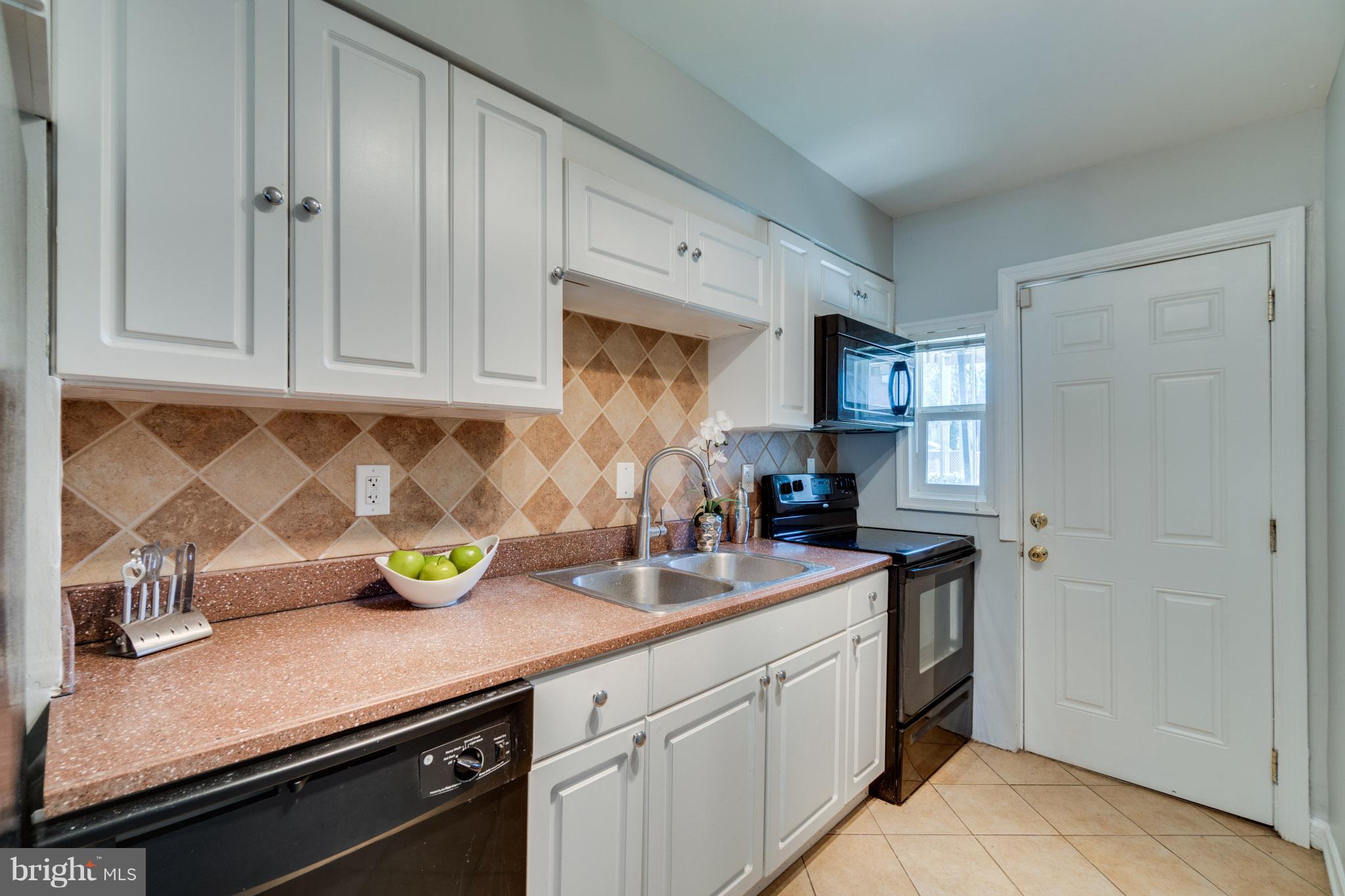 1911 D Street Northeast Washington, DC 20002 - Photo 12 of 25 a kitchen with a sink and cabinets