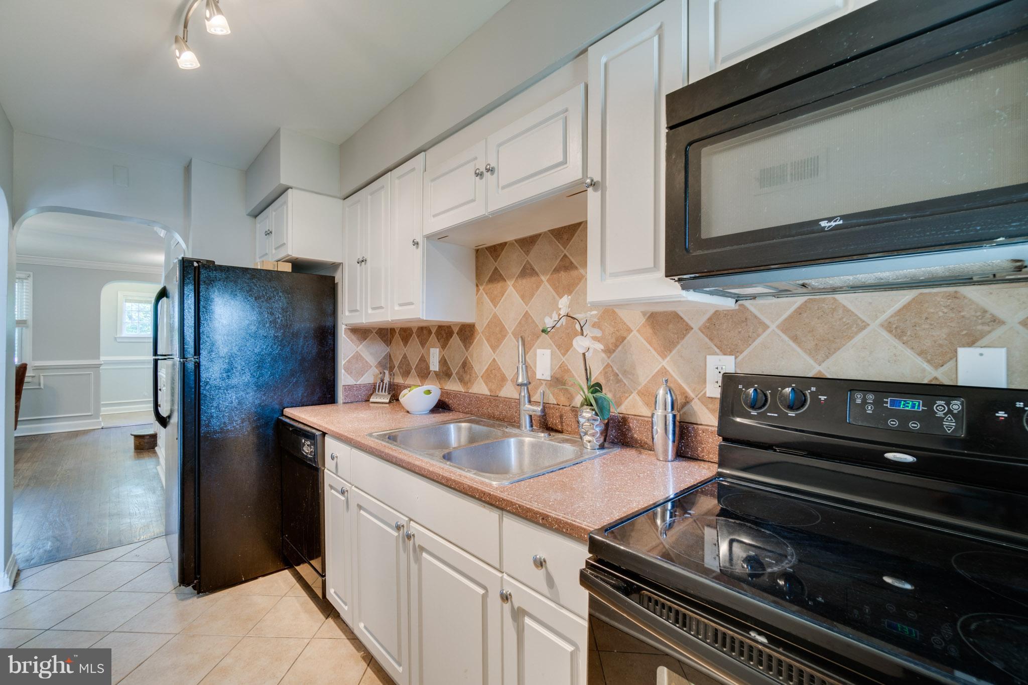 1911 D Street Northeast Washington, DC 20002 - Photo 13 of 25 a kitchen with a stove and a microwave