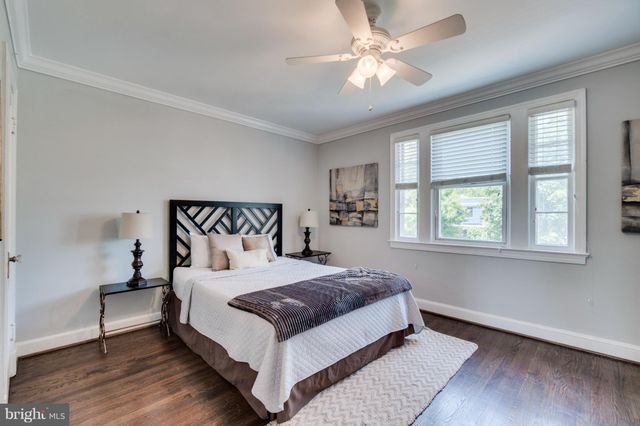 a bedroom with a large bed and a large window