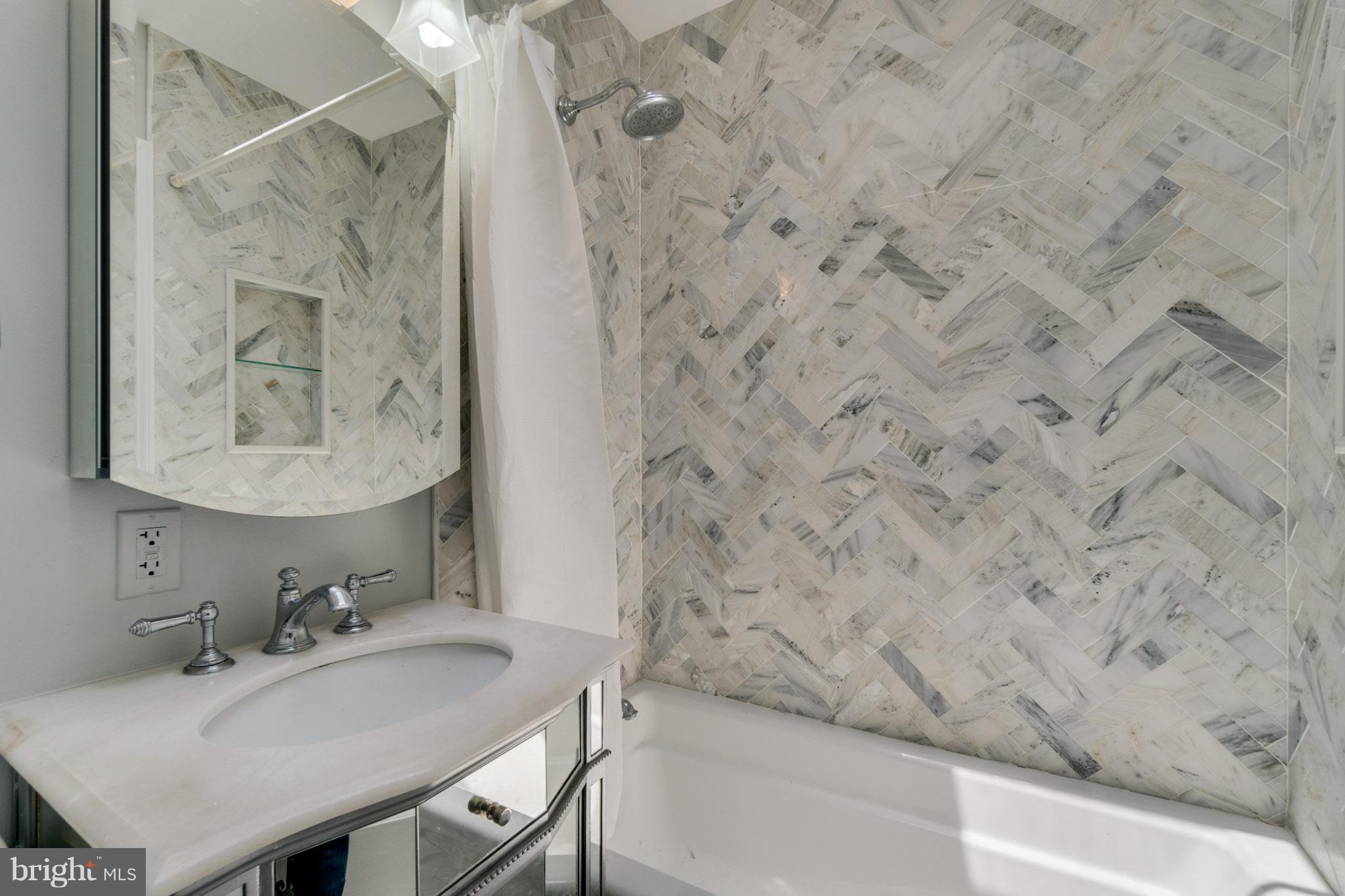 1911 D Street Northeast Washington, DC 20002 - Photo 17 of 25 a bathroom with a sink and a mirror