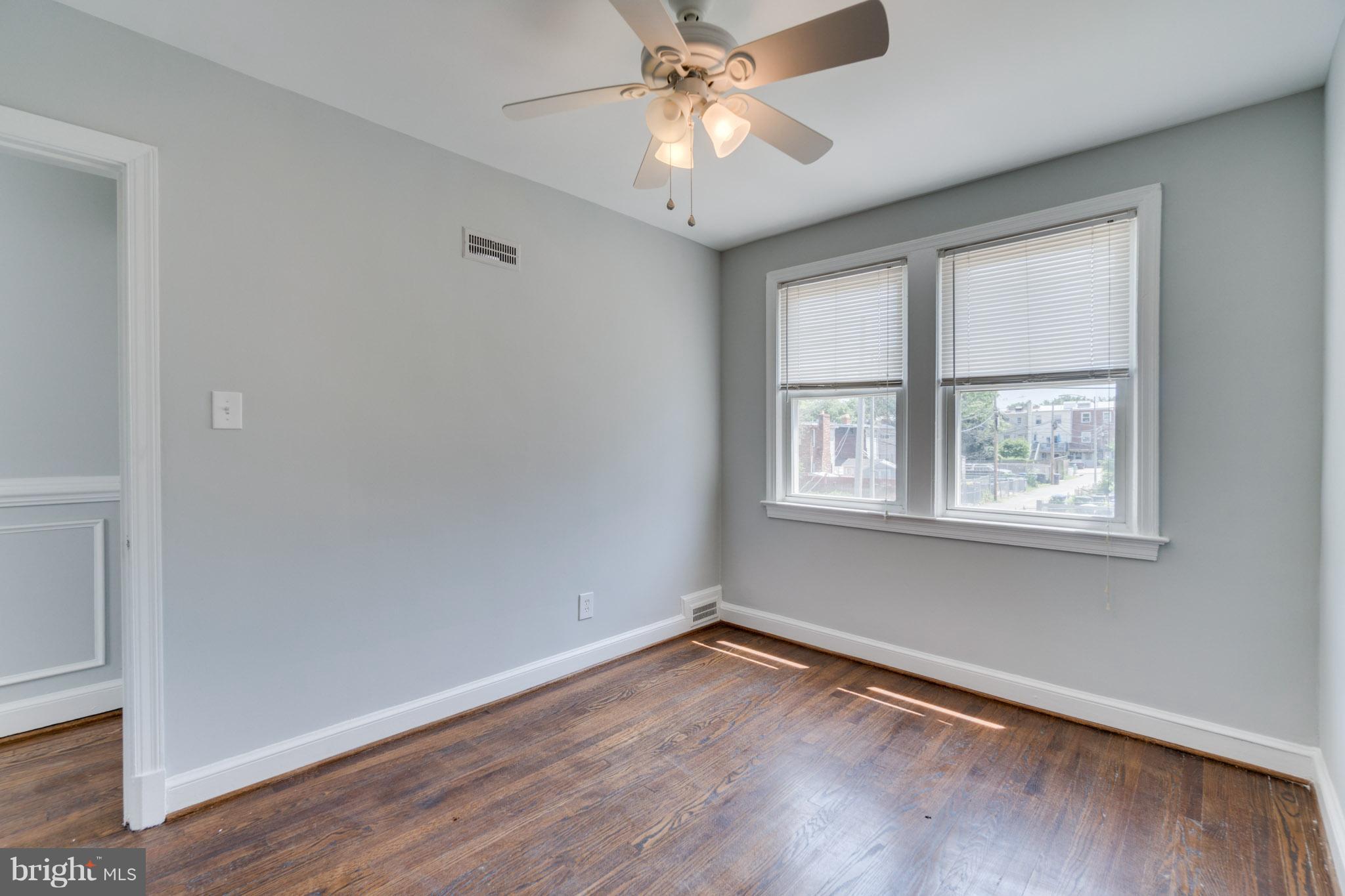 1911 D Street Northeast Washington, DC 20002 - Photo 18 of 25 a view of an empty room with wooden floor and a window