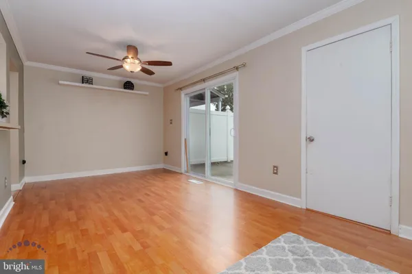 a view of an empty room and kitchen view