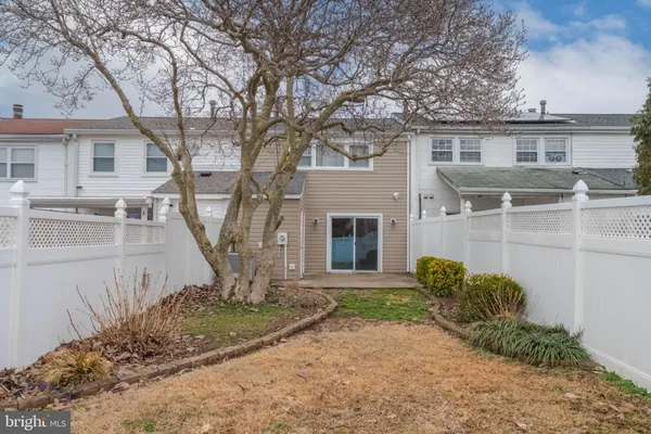 a view of a house with backyard and a tree