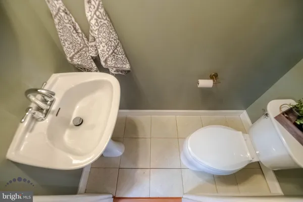 a bathroom with a toilet and a mirror