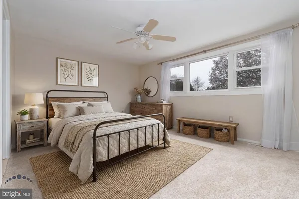 a bedroom with a bed a table and chair